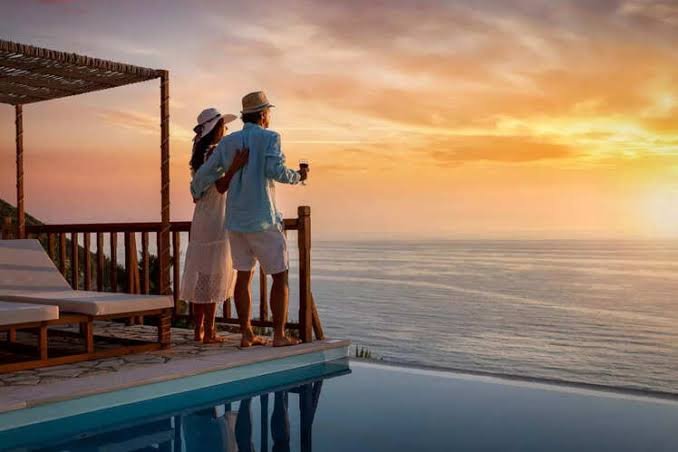 Newlywed couple enjoying a romantic beach sunset on their honeymoon