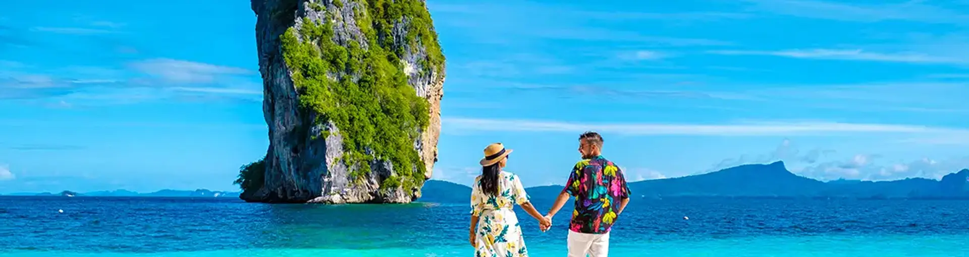 Couple on a sunset sailing trip during an international honeymoon